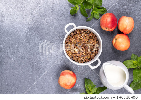 Granola cereal with milk nectarine and fresh mint Granola cereal with milk nectarine and fresh mint 140518400