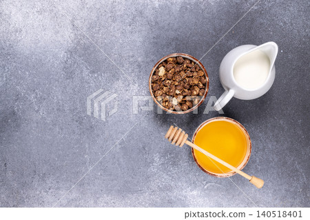 Granola cereal with milk and honey for healthy breakfast Granola cereal with milk and honey for healthy breakfast 140518401