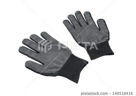 two black knitted gloves with dots lying at an angle on a white background separate from each other two black knitted gloves with dots lying at an angle on a white background separate from each other 140518416