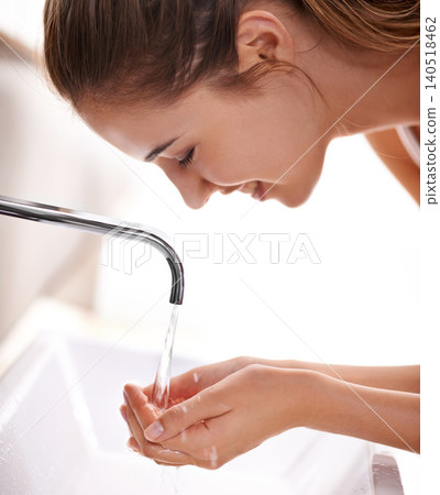 Woman closeup and water with washing face and hygiene in sink for self care and beauty with smile in restroom. Female person, cleaning and tap in bathroom, morning and happy for health at home Woman closeup and water with washing face and hygiene in sink for self care and beauty with smile in restroom. Female person, cleaning and tap in bathroom, morning and happy for health at home 140518462