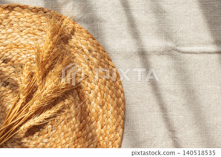 Golden wheat ears resting on rustic wicker mat Golden wheat ears resting on rustic wicker mat 140518535