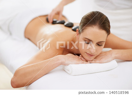 Relax, hot stone massage and girl at spa for health, wellness and luxury holistic treatment. Self care, zen and woman in natural body therapy, comfort and calm pamper service at hotel with therapist Relax, hot stone massage and girl at spa for health, wellness and luxury holistic treatment. Self care, zen and woman in natural body therapy, comfort and calm pamper service at hotel with therapist 140518596
