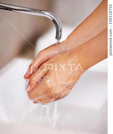 Hands, water and soap for person cleaning in skincare, routine and grooming in home closeup. Bathroom, tap and washing skin with foam for sanitary protection of hygiene from germs, bacteria and virus Hands, water and soap for person cleaning in skincare, routine and grooming in home closeup. Bathroom, tap and washing skin with foam for sanitary protection of hygiene from germs, bacteria and virus 140518758
