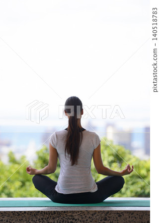 Woman, meditation and yoga with mat by window for workout, exercise or spiritual wellness at home. Rear view of female person or yogi meditating in relax for inner peace, zen or fitness at the house Woman, meditation and yoga with mat by window for workout, exercise or spiritual wellness at home. Rear view of female person or yogi meditating in relax for inner peace, zen or fitness at the house 140518783