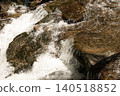 Mossy rocks in fast flowing mountain stream close up 140518852