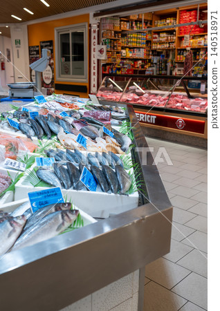 Milan, italy, october 2, 2024. Variety of fresh seafood and fish on ice with price tags, ready for sale at a bustling market stall in milan Milan, italy, october 2, 2024. Variety of fresh seafood and fish on ice with price tags, ready for sale at a bustling market stall in milan 140518971