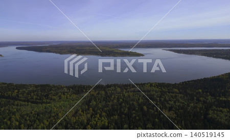 Calm Forested Coast With Reflective Ambiance. Tranquil Shoreline Covered In Trees Blending Into Sky . Clip Calm Forested Coast With Reflective Ambiance. Tranquil Shoreline Covered In Trees Blending Into Sky . Clip 140519145