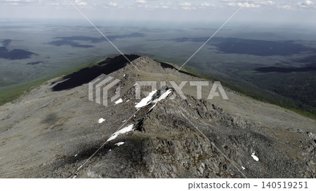 Surveying High Mountain Ridge With Snow Remnants And Surrounding Forested Lowlands From Above. Media Surveying High Mountain Ridge With Snow Remnants And Surrounding Forested Lowlands From Above. Media 140519251