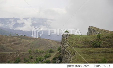 One tree overlooking the mountain and warm light. Creative One tree overlooking the mountain and warm light. Creative 140519293