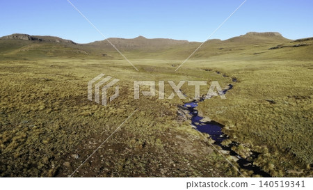 Unmanned Aerial Perspective Highlighting Flowing Stream Amid Expansive Natural Wilderness Landscapes. Media Unmanned Aerial Perspective Highlighting Flowing Stream Amid Expansive Natural Wilderness Landscapes. Media 140519341