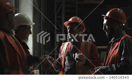 Industrial Team In Safety Gear Strategize Over Project Responsibilities Amidst Equipment And Scaffolding . Stock clip Industrial Team In Safety Gear Strategize Over Project Responsibilities Amidst Equipment And Scaffolding . Stock clip 140519343