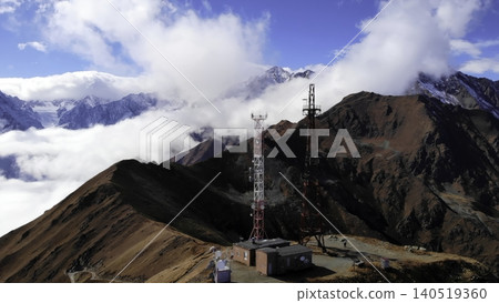 Secluded Communications Mast Atop Frosty Ridges Overlooking Thick Fog And Pristine Mountain Vistas. Media Secluded Communications Mast Atop Frosty Ridges Overlooking Thick Fog And Pristine Mountain Vistas. Media 140519360