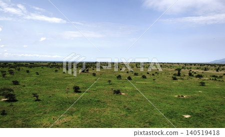 Elevated Observation Capturing Expansive Green Plain Dotted With Varied Hills Under Clear Blue Sky. Media Elevated Observation Capturing Expansive Green Plain Dotted With Varied Hills Under Clear Blue Sky. Media 140519418