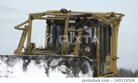 Heavy Steel Bulldozer With Hydraulic Arms Actively Clearing Snow In Cold Industrial Environment . Stock clip Heavy Steel Bulldozer With Hydraulic Arms Actively Clearing Snow In Cold Industrial Environment . Stock clip 140519504
