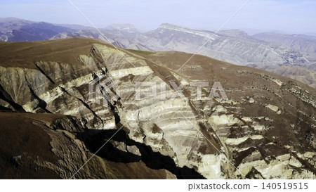 Aerial Shot Of Rugged Terrain. Media. Remote Desert Plateau Reveals Layered Geological Formations And Textures Aerial Shot Of Rugged Terrain. Media. Remote Desert Plateau Reveals Layered Geological Formations And Textures 140519515