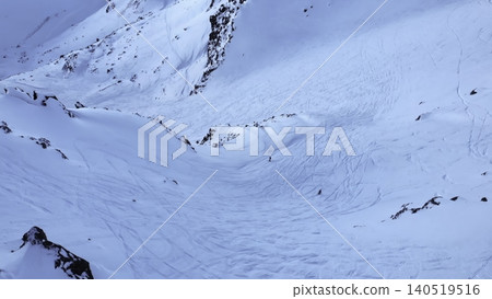 Tranquil Snow Covered Hillside With Rocks. Calm Icy Mountain Slope Bathed In Delicate Blue Rays Of Light. Media Tranquil Snow Covered Hillside With Rocks. Calm Icy Mountain Slope Bathed In Delicate Blue Rays Of Light. Media 140519516