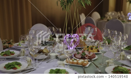 Sumptuous Event Space Showcasing Gleaming Glasses Complemented By Vibrant Green Accents Above Tables. Creative Sumptuous Event Space Showcasing Gleaming Glasses Complemented By Vibrant Green Accents Above Tables. Creative 140519548