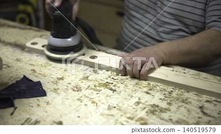 Experienced Technician Precisely Calibrates Pressure During Extensive Wood Polishing Tasks. Media 140519579