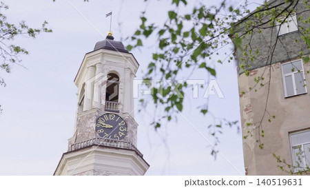 Clock With Greenery. Peaceful Urban Corner With Ornate Clock Tower And Blooming Foliage During Sunrise. Creative Clock With Greenery. Peaceful Urban Corner With Ornate Clock Tower And Blooming Foliage During Sunrise. Creative 140519631