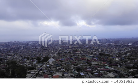 Cloudy Cityscape Overview. Overhead Image Capturing Congested Rooftops Near Stormy Sky And Distant Sea. Media Cloudy Cityscape Overview. Overhead Image Capturing Congested Rooftops Near Stormy Sky And Distant Sea. Media 140519632