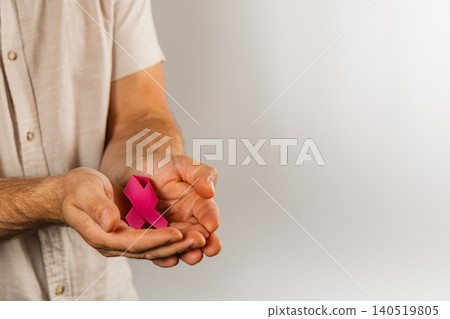 Support for health awareness with a ribbon held in hands Support for health awareness with a ribbon held in hands 140519805