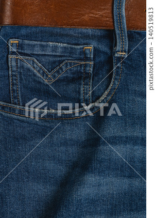 Closeup of denim jeans with pocket and belt showing fabric texture Closeup of denim jeans with pocket and belt showing fabric texture 140519813