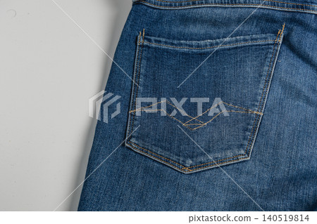 Closeup of blue denim jeans pocket showing stitching and fabric texture Closeup of blue denim jeans pocket showing stitching and fabric texture 140519814