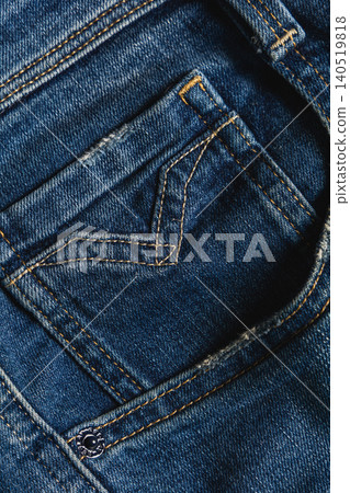 Detail of a denim pocket on blue jeans showing stitching and fabric texture Detail of a denim pocket on blue jeans showing stitching and fabric texture 140519818