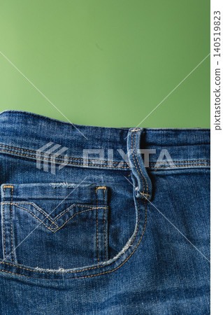 Close up view of a denim pocket showing stitch details and fabric texture 140519823