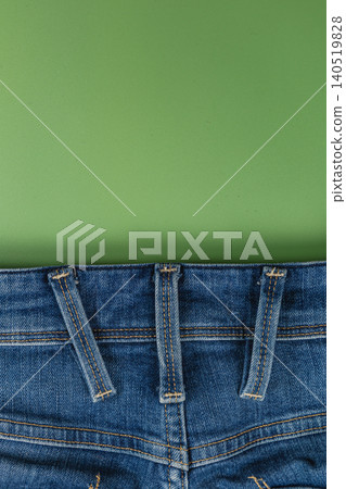 Closeup of denim jeans pocket on a solid background with space Closeup of denim jeans pocket on a solid background with space 140519828