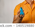 Support for health awareness with a blue ribbon held by a man 140519880