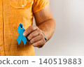 Support for health awareness with a blue ribbon held by a man 140519883
