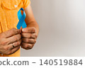Ribbon held by a man symbolizing support for health campaigns and awareness 140519884