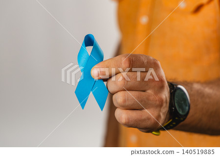 Awareness ribbon held by a man for health support and community care 140519885