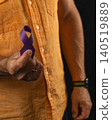 Supporting health awareness with a purple ribbon in hands 140519889