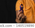Man holds purple awareness ribbon to support health campaign 140519890