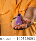 Support for health awareness with a ribbon in hand 140519891