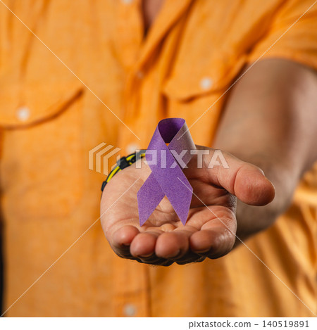 Support for health awareness with a ribbon in hand 140519891