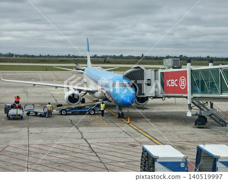 Cordoba, Argentina - April 20, 2026: Close view of an Aerolineas Argentinas aircraft at the boarding bridge. Cordoba, Argentina - April 20, 2026: Close view of an Aerolineas Argentinas aircraft at the boarding bridge. 140519997