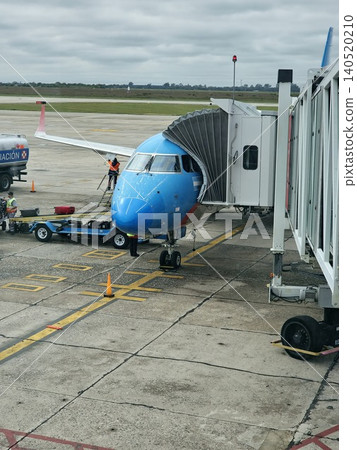 Cordoba, Argentina - April 20, 2026: Close view of a passenger aircraft through terminal windows at Taravella Airport. Cordoba, Argentina - April 20, 2026: Close view of a passenger aircraft through terminal windows at Taravella Airport. 140520210