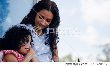 Latino mother and young daughter bonding outdoors Latino mother and young daughter bonding outdoors 140520537