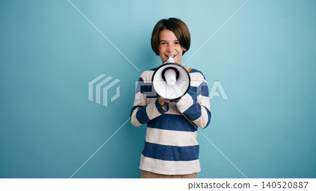 Boy shouting into megaphone making an announcement Boy shouting into megaphone making an announcement 140520887