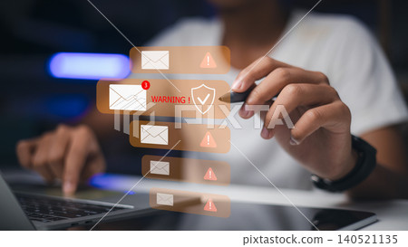 person holding stylus pen near virtual email notifications with warning sign and shield icon. Concept of cyber security, phishing awareness, spam alert and data protection. 140521135