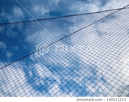 Blue sky reflected in the net fence 2 Blue sky reflected in the net fence 2 140521213