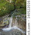 Spring water flowing into the mountain stream 140522016