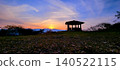 A silhouette of a gazebo against a sunset sky. 140522115