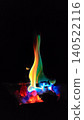 Rainbow-colored flames and a fantastical bonfire floating in the darkness 140522116