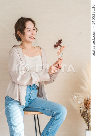 High chair, female model in denim sitting on chair High chair, female model in denim sitting on chair 140522136