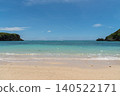 Land on both sides, emerald green sea with a visible horizon and white sandy beaches. 140522171