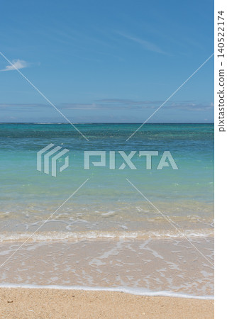 Emerald green sea with a horizon and white sandy beaches 140522174
